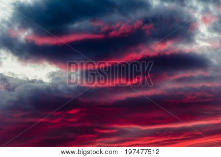 mysterious fiery sky with altocumulus clouds at sunset