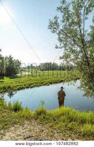 The fisherman catches a pike for spinning off the bank of the channel