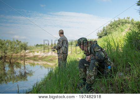 The fisherman catches a pike for spinning off the bank of the channel