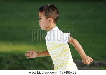 Japanese Boy Running On The Grass (second Grade At Elementary School)