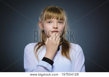 Closeup Portrait of little girl going surprise on gray background.