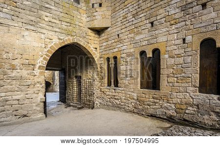 Stone arch and gate of a castle in Peratallada, Spain