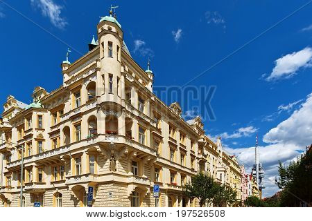 PRAGUE CZECH REPUBLIC - JULY 04 2016: Modern style residential building and socialistic era TV translating tower in Zizkov area
