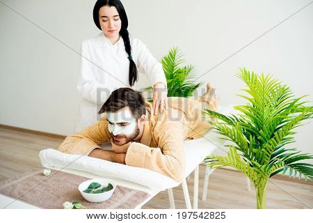 Man relaxing on massage table in spa salon