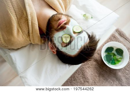 A portrait of a man with a clay mask
