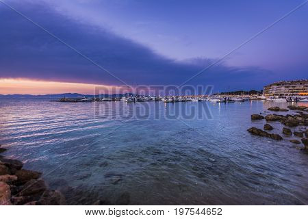 Sunset or blue hour in quiet port of l'Escala, Costa Brava, Spain. Mediterranean Sea