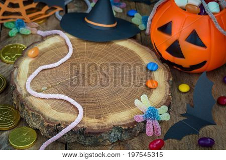 Halloween Jack o Lantern bucket overflowing with candy spooky Halloween decorations horizontal copy space