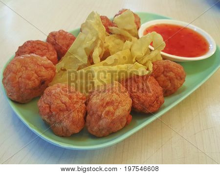 shrimp seafood meatball served with crispy fried wonton on plate / shrimp meatball