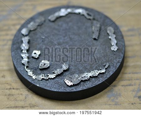 The working disk of the laser unit for melting the metal and the remains of the model printed on it