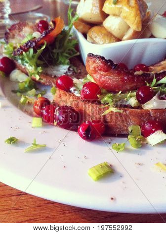 Delicious starter food (appetiser) - bacon, cranberries, mushrooms