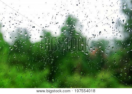 Water drops on a window on green blurred background