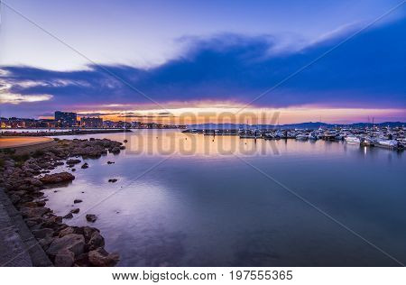 Sunset or blue hour in quiet port of l'Escala, Costa Brava, Spain. Mediterranean Sea