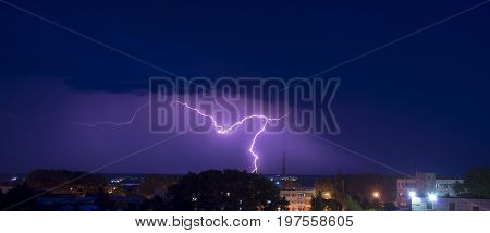 night thunderstorm over the buildings in the city