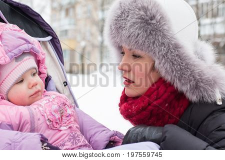Beautiful Mom And Nice Baby Outdor In A Winter