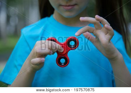 Little Girl Is Playing Spinner In Hand