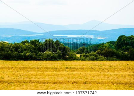 Very faraway mountains on horizon the view from field over the valley.
