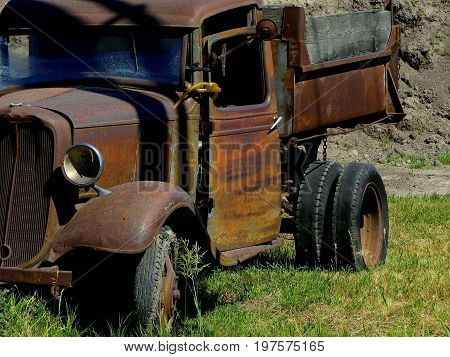 A rusty, old, vintage truck from a bygone era.
