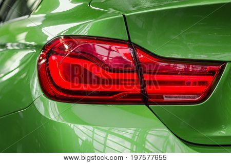 Close-up sports car rear tail-lamp with brakelight stop signal
