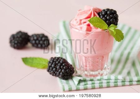Soft homemade whipped berry ice cream garnished with fresh raspberry copy space