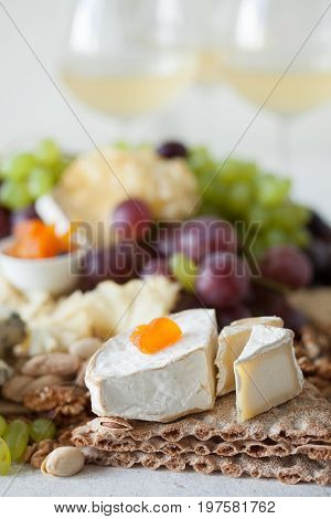 Cheese Plate Served With Grapes, Jam, Cured Melon, Crackers And Nuts