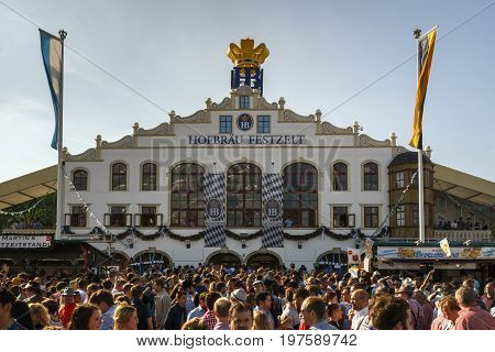 Munich, Germany - September 24, 2016: Facade and entrance of the Hofbraeu beer tent with unidentified people standing in front
