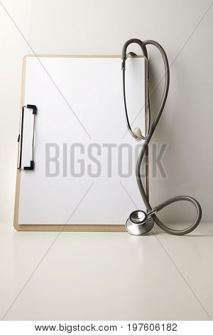 stethscope and blank clipboard