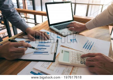 Co working conference Business team meeting present investor colleagues discussing new plan financial graph data on office table with laptop and calculator Finance accounting investment.