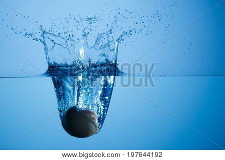 Egg thrown into the water generating splash at high speed