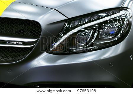 Sankt-Petersburg Russia July 21 2017: Front view of a Mercedes Benz C 63s AMG coupe 2017. Front Headlight. dark Matt colour .Car exterior details. Photo Taken at Royal Auto Show July 21