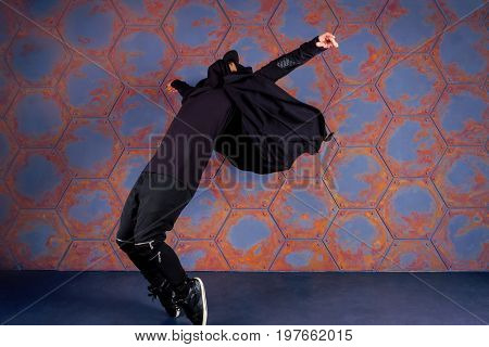 Young dancer standing on his tiptoes. Urban style