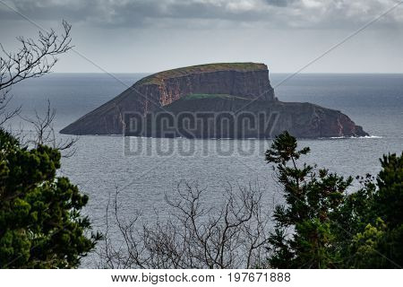 South of Terceira island with goat island at dusk in Azores Portugal