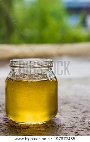 Honey In Jar And Window With Green On Backcground
