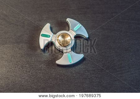 Famous Fidget Spinner Stress Relieving N A Black Wooden Background