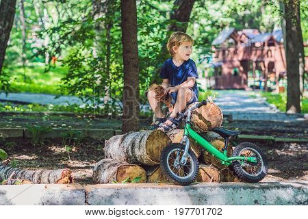 Little boy and his bicycle. Preschool child's first day on the bike. The joy of movement.
