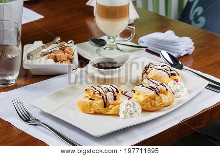 Eclairs with the dark hot chocolate and beze