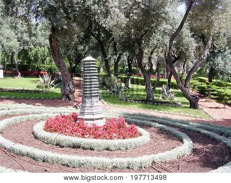 Flowerbed with sculpture in Bahai Gardens in Haifa Israel