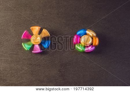 Famous Fidget Spinner Stress Relieving N A Black Wooden Background