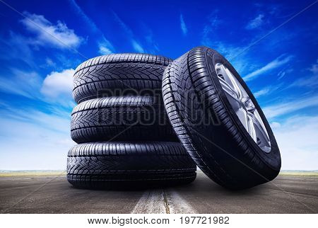 four car wheels under a blue sky