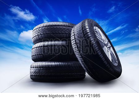 four car wheels under a blue sky