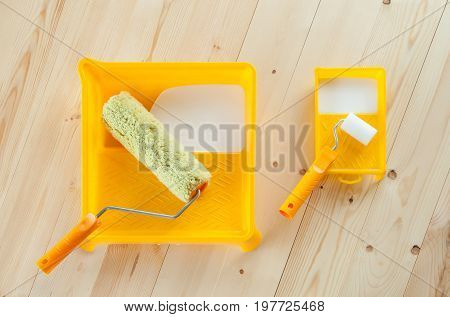 1245568 Paint Roller Brush With White Paint On Wooden Background