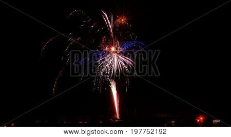 The bursting of fireworks fills the night.