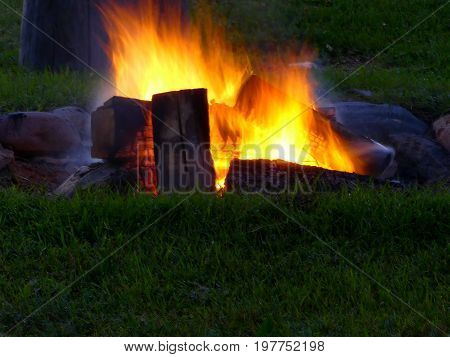 The warm glow of a roaring campfire.