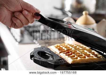 hash browns made in waffle maker kitchen hack. Just cooked, delicious, tasty, hot potatoes waffles with on waffle iron. Dinner is ready. Sweet golden brown waffles