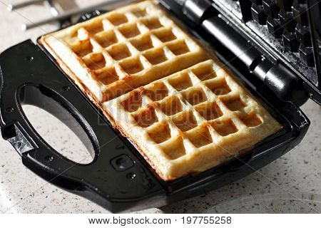 hash browns made in waffle maker kitchen hack. Just cooked, delicious, tasty, hot potatoes waffles with on waffle iron. Dinner is ready. Sweet golden brown waffles