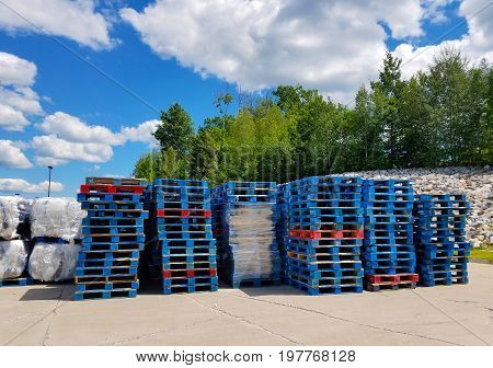 Stacks of palettes on a sunny, summer day