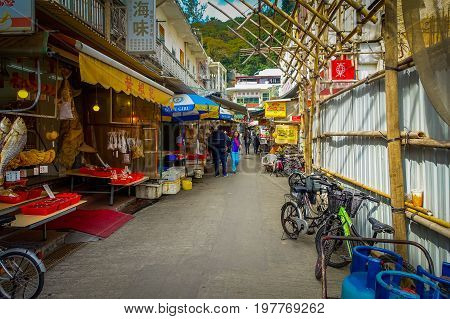 HONG KONG, CHINA - JANUARY 26, 2017: Unidentified people buying resh seafood in a market, in fishermen town in lantau, Hong Kong, China.