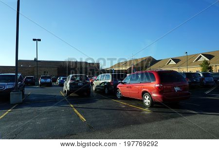 JOLIET, ILLINOIS / UNITED STATES - DECEMBER 4, 2015: Automobiles are parked in the parking lot of the Drauden Point Middle School.