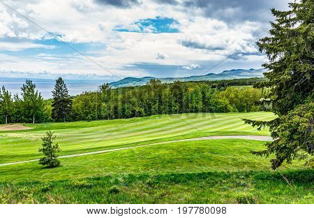 Landscape View Of Green Golf Course With Hills In Summer In La Malbaie, Quebec, Canada In Charlevoix