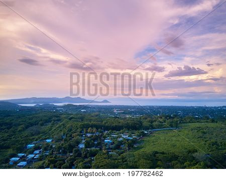 Pink sky over managua city landscape at dusk time aerial view