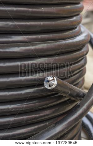 Electric Black Industrial Underground Cable On Large Wooden Reel